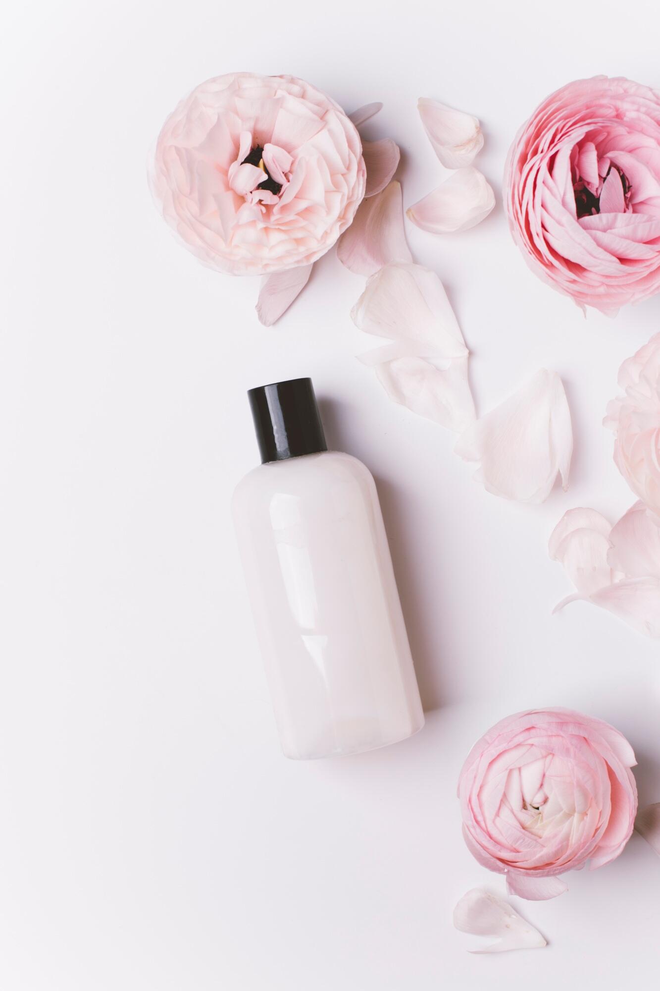 top view of shower gel and flowers isolated on white background